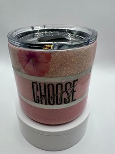 a close up of a cup on a white surface with the word choose painted on it