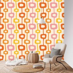 an orange, pink and yellow wallpaper in a living room with a white chair