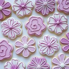 purple and white decorated cookies with flowers on them