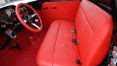 the interior of an old car with red leather seats