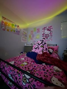 a bedroom with hello kitty bedding and colorful lights on the wall above the bed