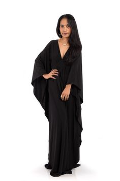 An amazing long trendy black gown, which stands out from the crowd because of its contemporary design. A black glamour dress like you havent seen before. This long elegant garment looks like a classic styled black dress at first but it features a funky, modern styled sleeves, which starts at the shoulder and runs all the way down. A true modern interpretation of the classic Roman toga. A subtle woven detail under the chest together with the butterfly styled sleeves makes this dress a must h... Black Flowy Long Sleeve Maxi Dress, Flowy Black Maxi Dress With Long Sleeves, Elegant Black Long Abaya, Bohemian Maxi Dress With Kimono Sleeves For Evening, Black Bohemian Maxi Dress For Night Out, Black Floor-length Abaya For Party, Black Long Abaya, Long Black Kaftan For Party, Black Maxi Dress With Kimono Sleeves For Summer