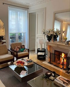 a living room filled with furniture and a fire place