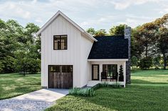 a small white house sitting on top of a lush green field