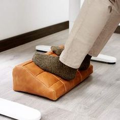 a person standing on top of a foot stool