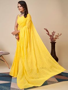 Elevate your wardrobe with our charming yellow sequins georgette haldi wear saree with blouse. This stunning saree is crafted with high-quality georgette material, featuring delicate thread embroidery and sequin work that adds a touch of elegance to the overall look. The vibrant yellow color of the saree is perfect for any festive occasion, especially haldi ceremonies.
The georgette fabric ensures a comfortable and flowy drape, making it easy to move and dance in. The matching art silk blouse co Georgette Material, Haldi Ceremony, Georgette Fabric, Silk Blouse, Overalls, Saree, Silk, Yellow, Festival