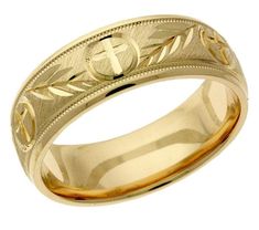 a gold wedding ring with an engraved cross on the center and leaves in the middle