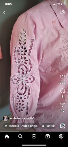 a pink shirt with an intricate design on it