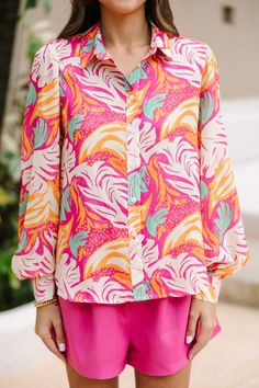 Trust me, you are going to want this button down blouse at your finger tips this spring and summer! That print and those hues are wonderfully bold and bright! You are going to love that this blouse can go from the office to the boardwalk too! Collared neckline Button down front closure Long bubble sleeves Colorful abstract print No stretch Sydney is wearing the small. Trendy Multicolor Print Button-up Blouse, Pink Summer Workwear Shirt, Pink Shirt For Workwear In Summer, Spring Multicolor Print Button-up Shirt, Spring Button-up Shirt With Multicolor Print, Spring Patterned Shirt With Bold Print, Long Sleeve Shirt With Tropical Print For Spring, Pink Vacation Blouse With Vibrant Print, Vacation Blouse With Vibrant Pink Print