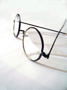 a pair of glasses sitting on top of a white surface