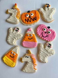 decorated cookies are arranged in the shape of ghost, pumpkins, and other items