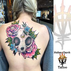 a woman with a skull and flowers tattoo on her back