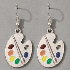 two pairs of earrings with paintbrushes painted on the front and back of them