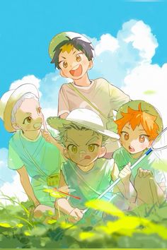 four children are posing for a photo in front of the blue sky and green grass