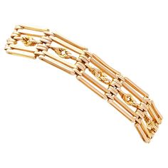 An exceptional, fine and impressive unusual 9 karat gold 5 bar gate bracelet; part of our diverse antique jewellery collections. This exceptional, fine and impressive antique bracelet has been crafted in 9k yellow gold. The gate style bracelet displays twelve interlocking links, each consisting of four horizontal bars and a central knot design; the additional ornamentation is unusual and desirable. These links conjoin and articulate via twelve groups of six oval links. The antique 1920s bracelet Gold Gate, Antique Bracelets, Bracelet Display, Knot Design, Antique Jewellery, Italian Charm Bracelet, Barrettes, Stone Jewelry, Link Bracelets