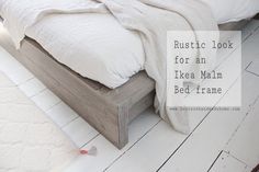 a bed with white sheets and blankets on top of it, next to a rug