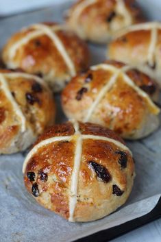 freshly baked hot cross buns on a baking sheet