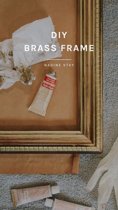 an old frame is being used to make a diy brass frame with paper and glue