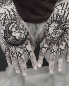 two hands that have tattoos on them