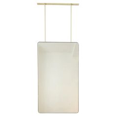 a white rectangular light hanging from a metal rod