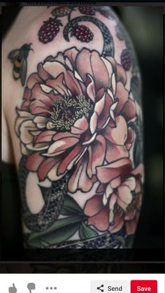 the back of a woman's shoulder with flowers and butterflies on her left arm