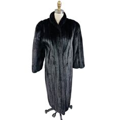 "This coat is in mint condition! It was fur-stored and it has not a single flaw. And it is truly black not dark brown. Amerimink is a high-end mink maker. It has 6 hook and eye closures down the front. Padded shoulders.  It is lined in a material I can't identify but it is smooth. There is a name embroidered in it. It was from Steins Furs of Distinction in Wilkes Barre PA. The approximate measurements are, laid flat: Pit to pit inside: 21\" Shoulders 15-16\" Length 47\" from shoulder. The sleeve is 23\" which is bracelet length. I show it on a size 6 mannequin and there room." Classic Black Fur Coat With Faux Fur Lining, Luxury Black Long Fur Coat, Classic Black Long Sleeve Fur Coat, Luxury Black Long Sleeve Fur Coat, Black Fur Coat For Evening In Fall, Cat Pajamas, Mink Coat, Vest Jacket, Mint Condition