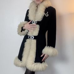 Experience timeless elegance with our Women Penny Lane Coat, a chic black shearling coat that combines vintage charm with modern style. This long fur coat features genuine wool construction and a cozy shearling lining, ensuring warmth and comfort. Inspired by 70s boho hippie fashion, this Afghan coat boasts a retro aesthetic perfect for any fashion-forward wardrobe. The luxurious fur trim adds a touch of sophistication, while the versatile design makes it a standout piece for any occasion. Embra Luxury Retro Fur Coat For Winter, Black Penny Lane Coat, Vintage Long Coat In Faux Fur, Chic Black Sheepskin Fur Coat, Fitted Black Sheepskin Fur Coat, Boho Hippie Aesthetic, Elegant Black Sheepskin Fur Coat, Black Shearling Coat, 70s Fur Trim Coat