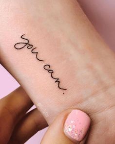 a woman's foot with the word love tattooed on her left ankle and pink nail polish