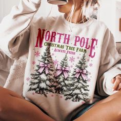 Get into the holiday spirit with our North Pole Christmas Tree Farm graphic sweatshirt in cream! Perfect for any occasion. *Will Ship in 3-5 Days* Size Suggestions: Small: 2-4 Medium: 6-8 Large: 10-12 XL: 14-16 2XL: 18-20 3XL: 22-24 Fabric Content: 52% Cotton 48% Polyester Care Instructions: Machine wash, cold. Tumble dry, low. Do not iron decoration. SKU: #243122 Winter Cream Sweater With Letter Print, Cream Winter Sweater With Letter Print, Cream Letter Print Sweater For Winter, Cream Winter Top With Letter Print, Cream Letter Print Top For Winter, Cream Tops With Letter Print For Winter, Winter Graphic Print Cream Tops, Winter Cream Tops With Graphic Print, Winter Cream Graphic Print Tops