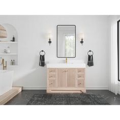 a bathroom with a sink, mirror and rug on the floor in front of it