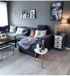 a living room filled with furniture and pictures on the wall