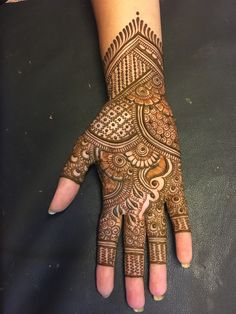 a woman's hand with hennap on it, showing the intricate design