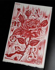 a red and white drawing of a rose on a piece of paper that says love