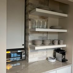 a kitchen counter with plates and cups on it