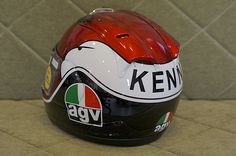 the helmet is red, white and black with an agv sticker on it