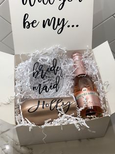 two bottles of wine in a box with congratulations written on the front and bottom, along with a card that says you're be my bride maid