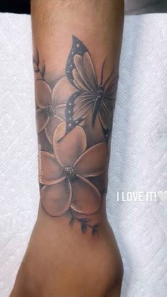 a woman's foot with flowers and butterflies on it