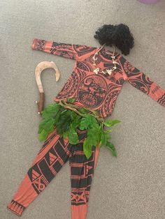 an orange and black costume is laying on the floor