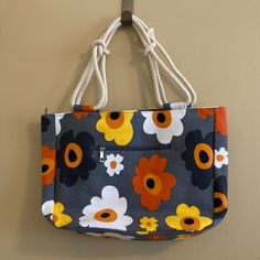 Cute Dark Gray Canvas Bag With Bright Flowers. Material Is Durable Canvas Like The One Used In Maine. Thick Sailor-Knotted Double Straps. Zippered Pocket In Front. Open Pocket And Zippered Pocket Inside. Whole Bag Zips Up. Measures 18" Wide X 12" Long X 5" Deep. Bag Was Featured In Paramount Tv Show "The Good Fight." Farmhouse Is My Style Summer Bloom. Nwt. Never Used. Yellow Canvas Bag For Spring Travel, Spring Yellow Canvas Bag For Daily Use, Retro Yellow Shoulder Bag For Daily Use, Everyday Yellow Floral Print Bags, Yellow Canvas Shoulder Bag With Handles, Yellow Floral Print Bag For Daily Use, Yellow Floral Print Bags For Daily Use, Retro Yellow Shoulder Bag For Shopping, Retro Yellow Bag For Daily Use