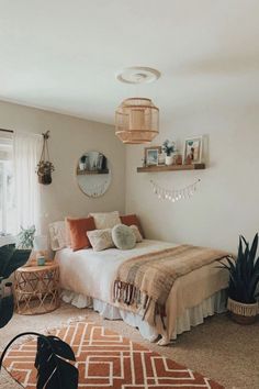 a bed room with a neatly made bed next to a window and potted plants