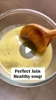 a wooden spoon in a glass bowl filled with liquid that is labeled perfect pain healthy soup