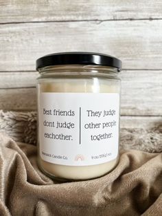 a jar of candles sitting on top of a blanket