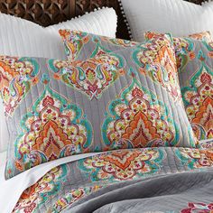 the comforter is made up with an intricate pattern on it's bedding