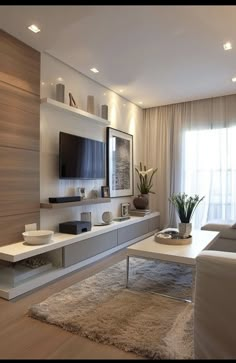 a modern living room with white furniture and wood paneling on the walls, along with a large flat screen tv