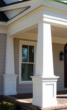 an image of a white house with columns on the front porch and windows in the back