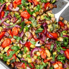 a pan filled with chopped vegetables and herbs