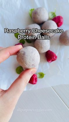 raspberry cheesecake protein balls are shown on a white plate with strawberries