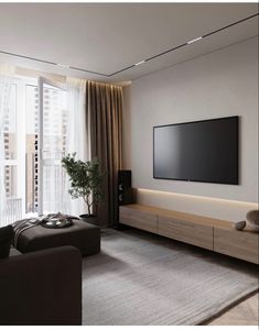 a large flat screen tv mounted on the wall in a living room next to a window