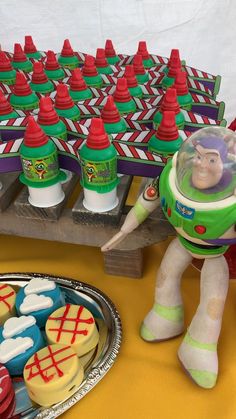 toy story buzz lightyear cake and cupcakes on a table