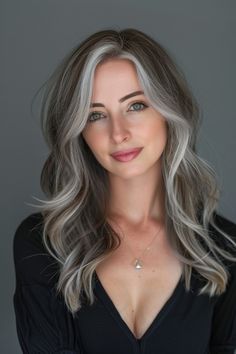 Charcoal grey transitioning to silver tips adds an elegant, timeless quality, perfect for a sophisticated look that blends shades of grey with a metallic sheen. Butterfly Haircut Gray Hair, Gray Hair Under 40, Brunette Hair With Gray Highlights, Butterfly Haircuts, Long Grey Hair